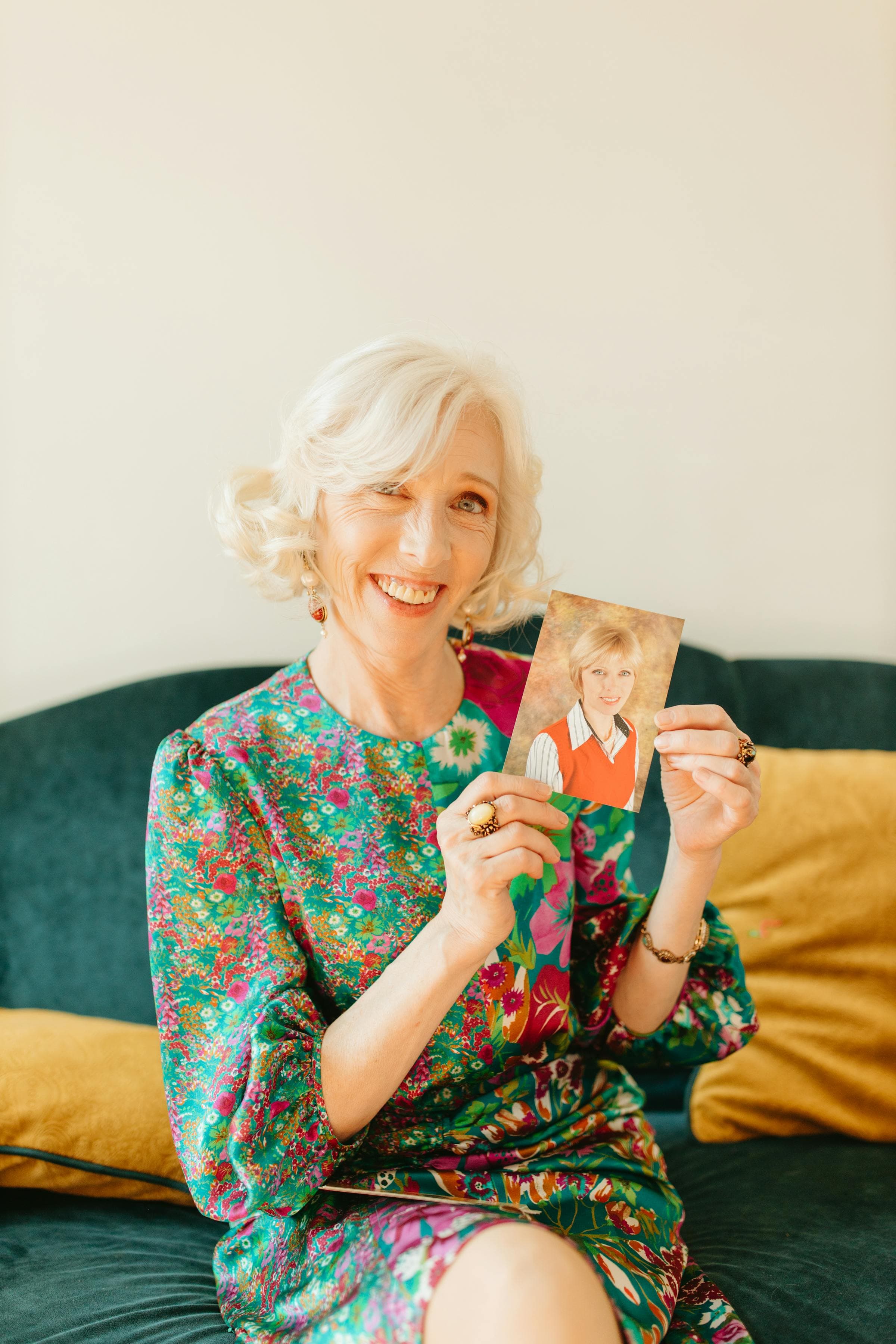 Elderly woman looking through old family photographs at home
